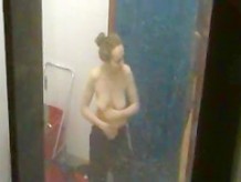 Sporty girls changing and showering in locker room