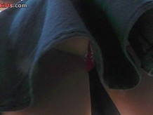 G-string wearing brunette filmed in upskirt video clip