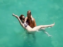 He teaches her how to swim