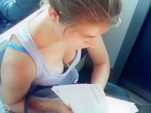 Gran escote en una chica leyendo en el tren