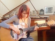 Pelirroja tocando la guitarra blusa y escote