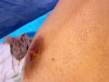 Adolescente con pequeñas tetas caídas exhibiéndose ante extraños en una playa pública